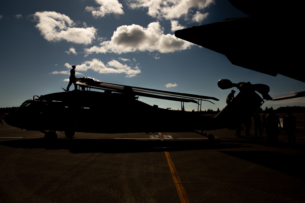 Checked baggage: Washington National Guard soldiers load Black Hawks into a C-17 Globemaster III