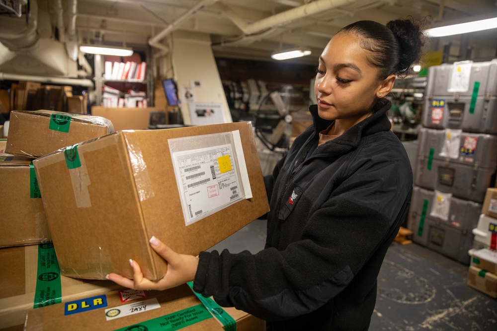 USS Gerald R. Ford (CVN 78) Sailor Processes Mail