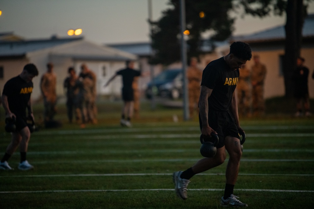 Soldier Runs with Weights During a Physical Test