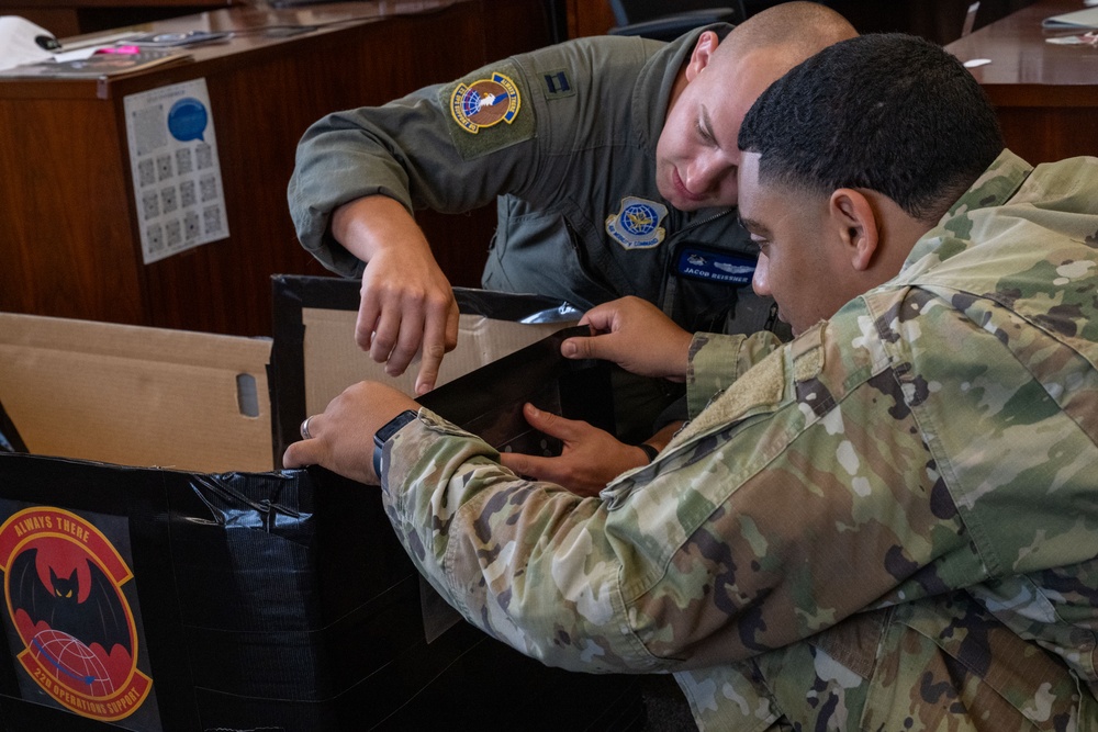 Sink or win: 22nd OSS flights compete in cardboard boat race