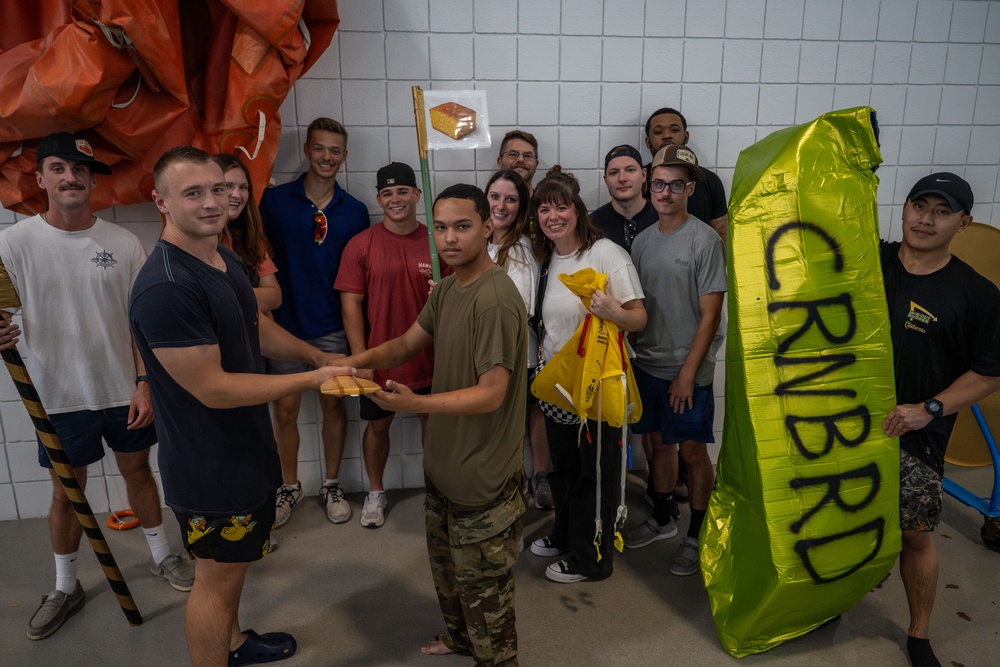 Sink or win: 22nd OSS flights compete in cardboard boat race