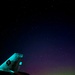The Aurora Borealis appears over Abraham Lincoln during exercise Northern Edge 2025