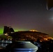 The Aurora Borealis appears over Abraham Lincoln during exercise Northern Edge 2025