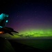 The Aurora Borealis appears over Abraham Lincoln during exercise Northern Edge 2025