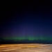 The Aurora Borealis appears over Abraham Lincoln during exercise Northern Edge 2025