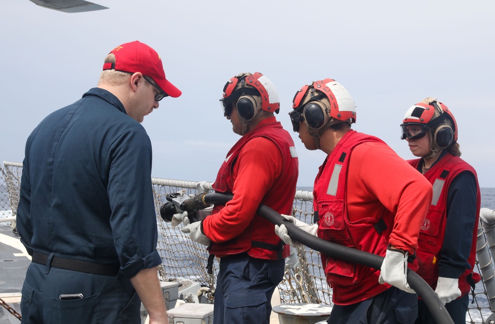 Sailors aboard the USS John Finn conduct a crash and salvage drill in the South China Sea