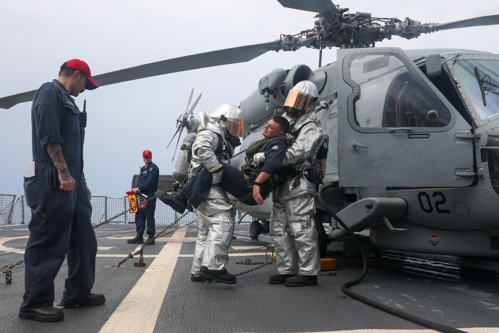 Sailors aboard the USS John Finn conduct a crash and salvage drill in the South China Sea