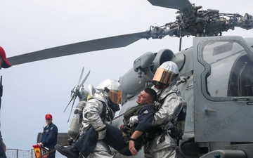 Sailors aboard the USS John Finn conduct a crash and salvage drill in the South China Sea