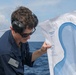Sailors aboard the USS John Finn conduct a small arms gun shoot in the South China Sea