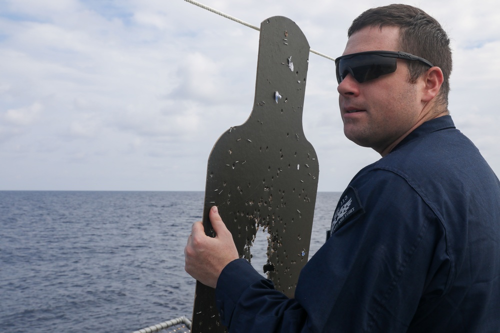 Sailors aboard the USS John Finn conduct a small arms gun shoot in the South China Sea