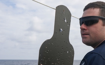 Sailors aboard the USS John Finn conduct a small arms gun shoot in the South China Sea