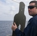 Sailors aboard the USS John Finn conduct a small arms gun shoot in the South China Sea
