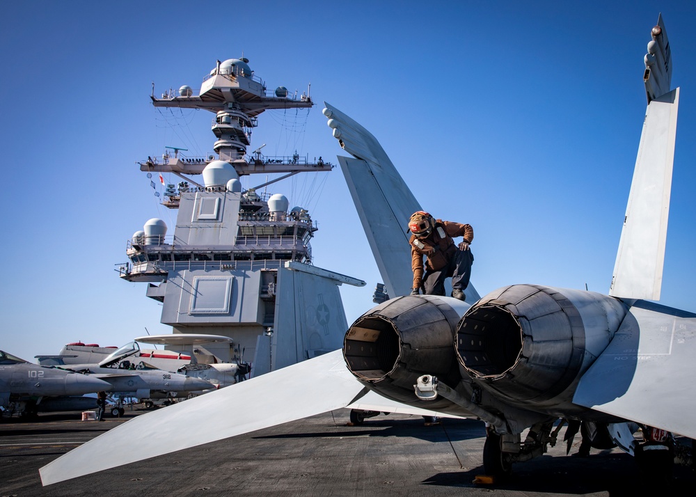 VFA-87 Sailor Inspects Jet