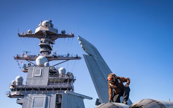 VFA-87 Sailor Inspects Jet