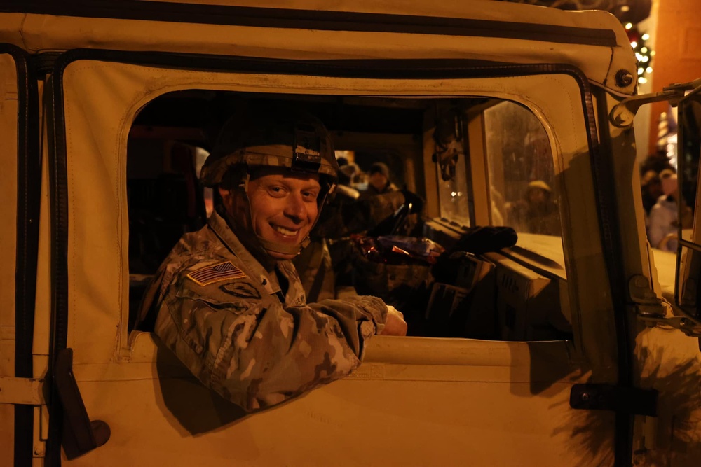 Soldier Rides in HMMWV at Holiday Parade