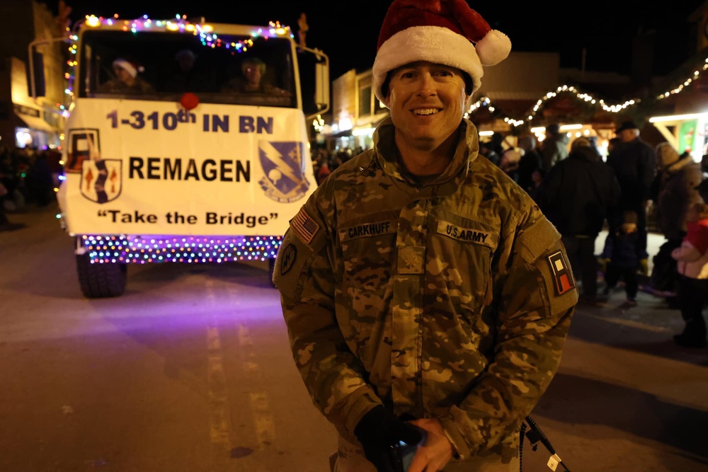 Soldier Poses for Photo during Holiday Parade