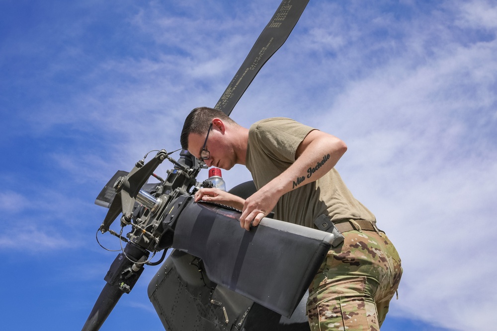 U.S. Army Soldier conducts maintenance on the rear tail blade of a UH-60 Blackhawk