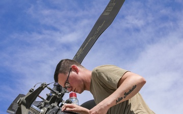 U.S. Army Soldier conducts maintenance on the rear tail blade of a UH-60 Blackhawk
