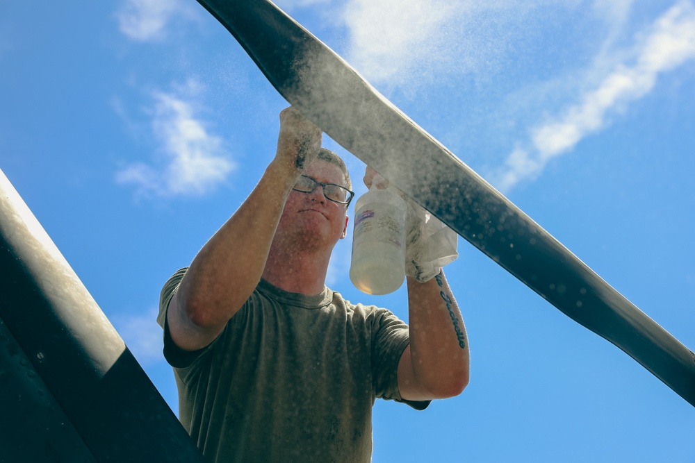 U.S. Army Soldier conducts maintenance on the rear tail blade of a UH-60 Blackhawk
