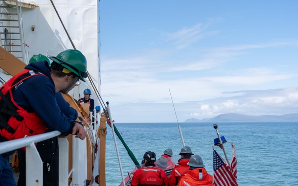 U.S. Coast Guard Cutter Healy transfers passengers offshore Nome