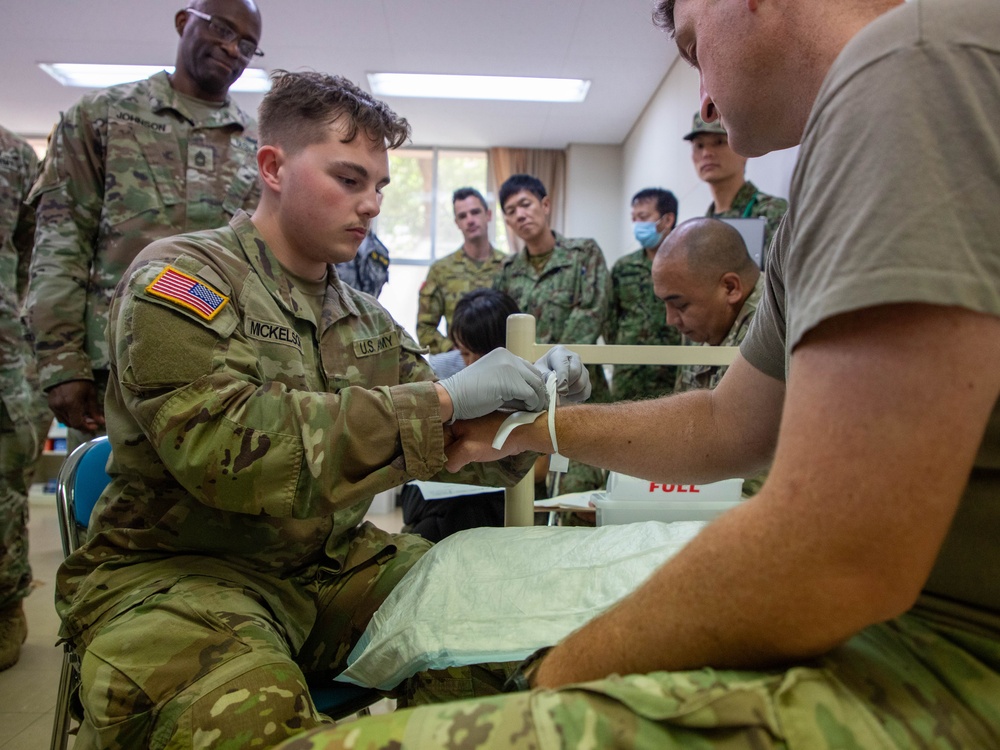 Medical personnel provide care during the Trilateral CASEVAC Training at Camp Asaka, Japan, Aug. 21, 2025.