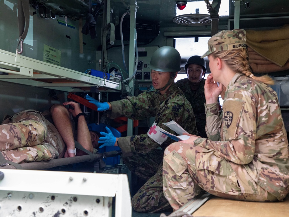 Medical personnel provide care during the Trilateral CASEVAC Training at Camp Asaka, Japan, Aug. 21, 2025.