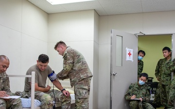 Medical personnel provide care during the Trilateral CASEVAC Training at Camp Asaka, Japan, Aug. 21, 2025.