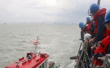 Sailors aboard the USS John Finn conduct a sea and anchor detail in Sembawang, Singapore