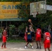 USS Frank Cable (AS 40) Sailors participate in sports with Guru Nanak College students