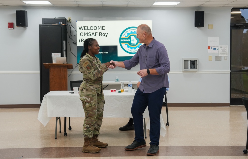Retired CMSAF Roy coins Staff Sgt. Debro