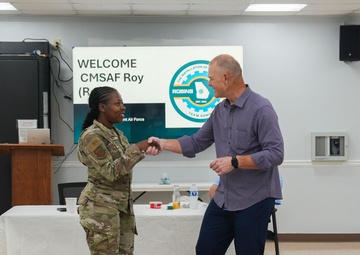 Retired CMSAF Roy coins Staff Sgt. Debro
