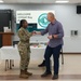 Retired CMSAF Roy coins Staff Sgt. Debro