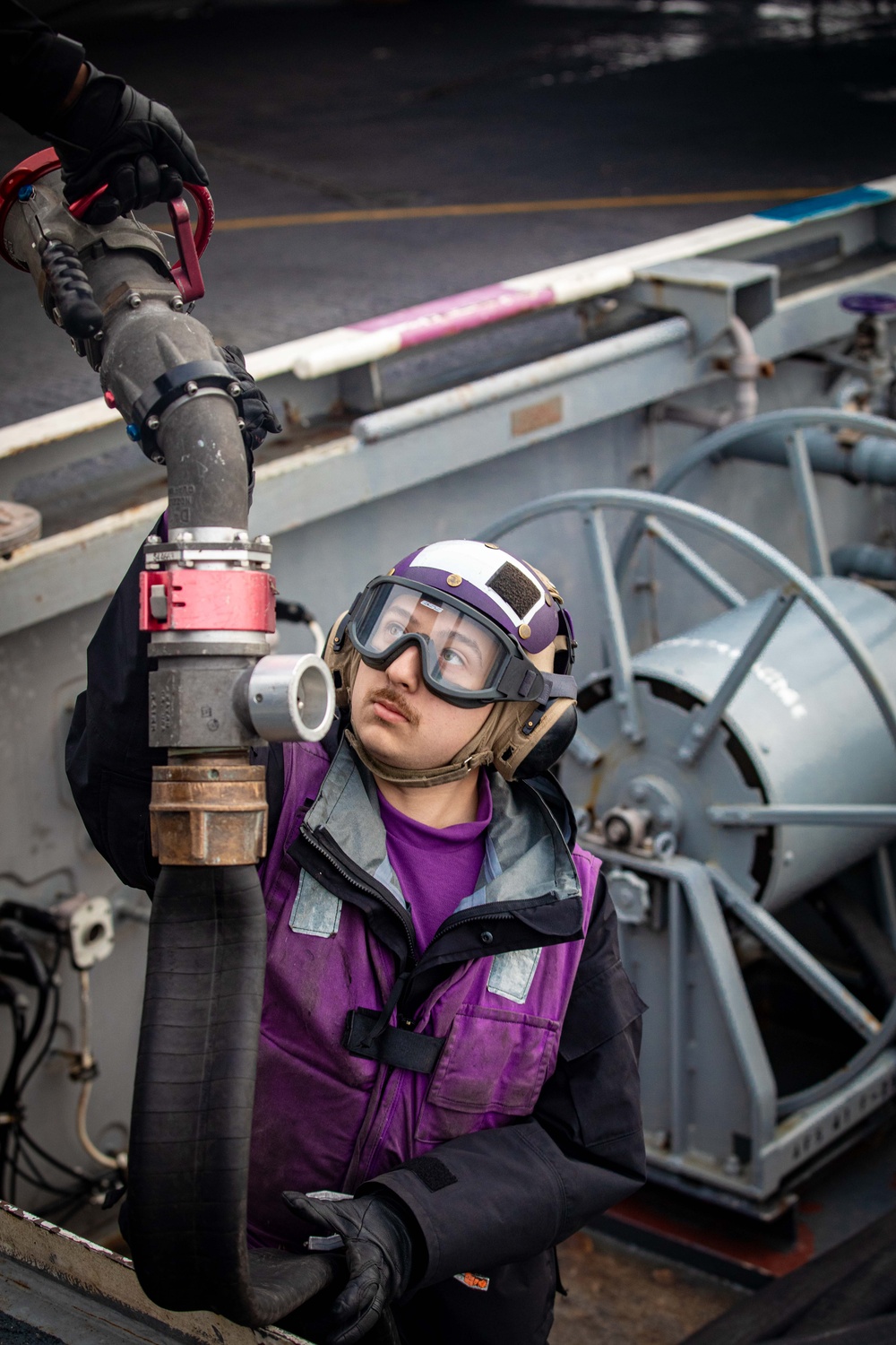 USS Gerald R. Ford (CVN 78) Sailor Lowers Fueling Hose