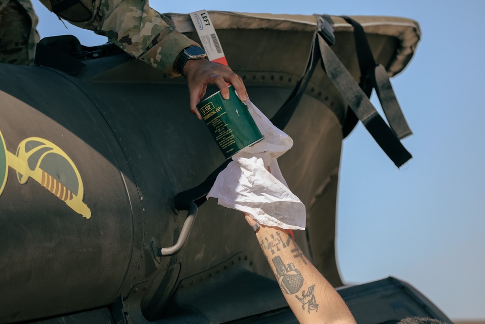 U.S. Army Soldiers conduct maintenance on a UH-60 Blackhawk