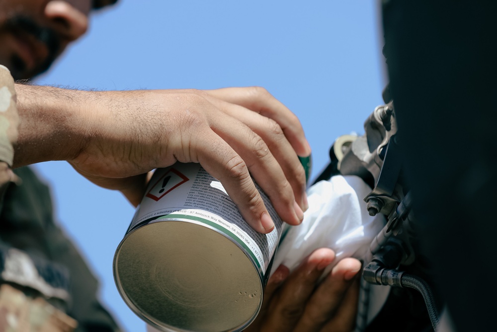 U.S. Army Soldiers conduct maintenance on a UH-60 Blackhawk