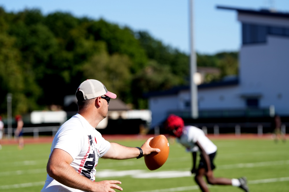 Burkham conducting drill with players at practice