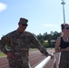 Burkham in uniform by track, smiling