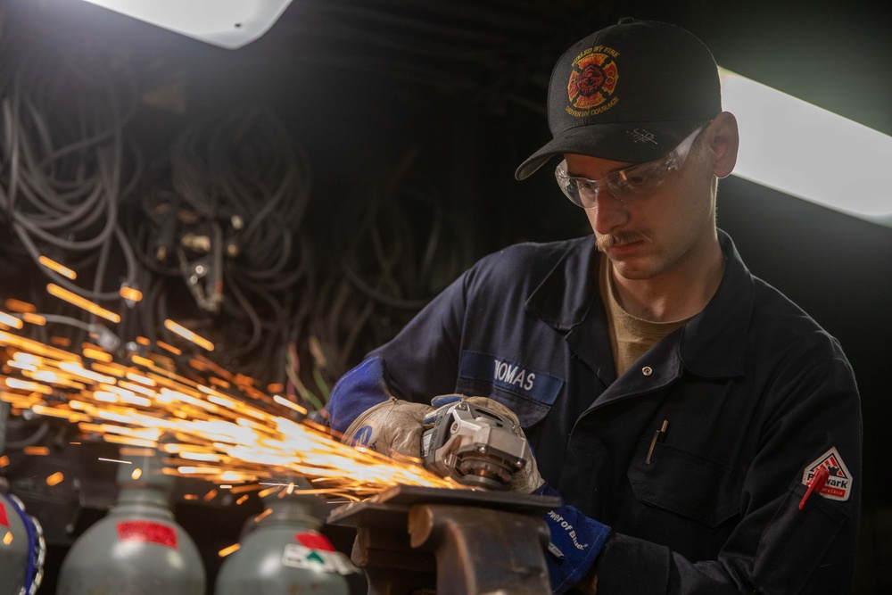 USS Gerald R. Ford (CVN 78) Sailor Grinds Weld
