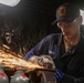 USS Gerald R. Ford (CVN 78) Sailor Grinds Weld