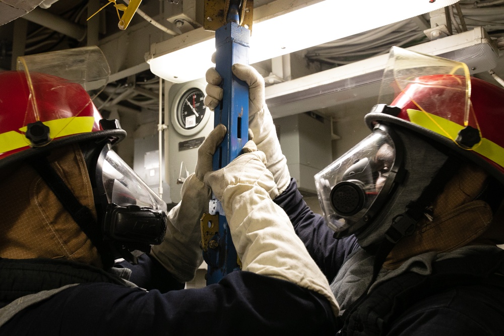 USS Mitscher (DDG 57) Sailors install shoring during GQ
