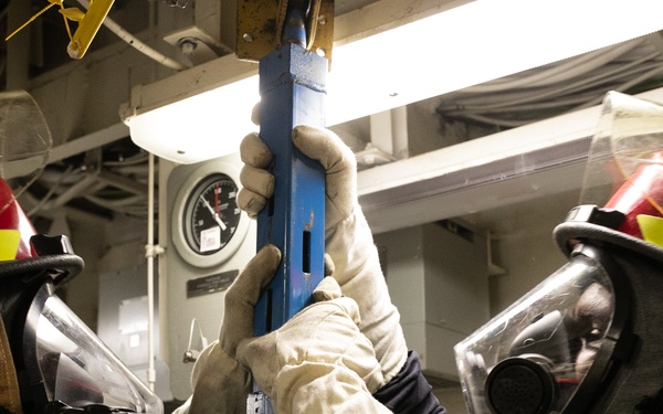 USS Mitscher (DDG 57) Sailors install shoring during GQ