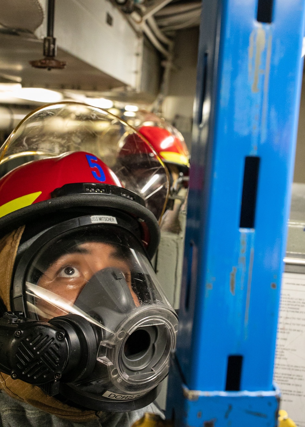 USS Mitscher (DDG 57) Sailor installs shoring during GQ