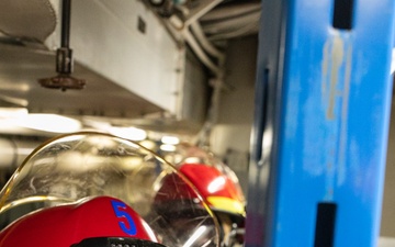 USS Mitscher (DDG 57) Sailor installs shoring during GQ