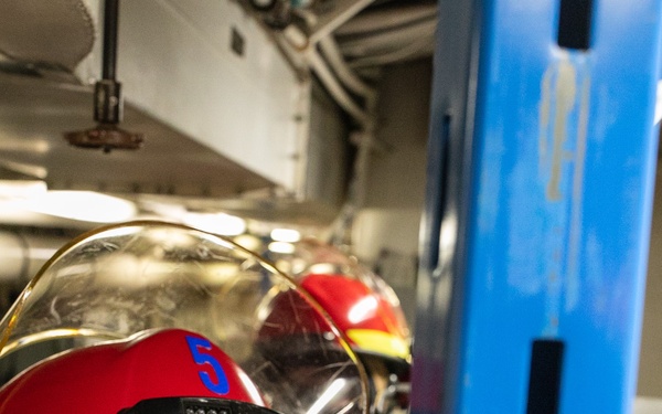 USS Mitscher (DDG 57) Sailor installs shoring during GQ