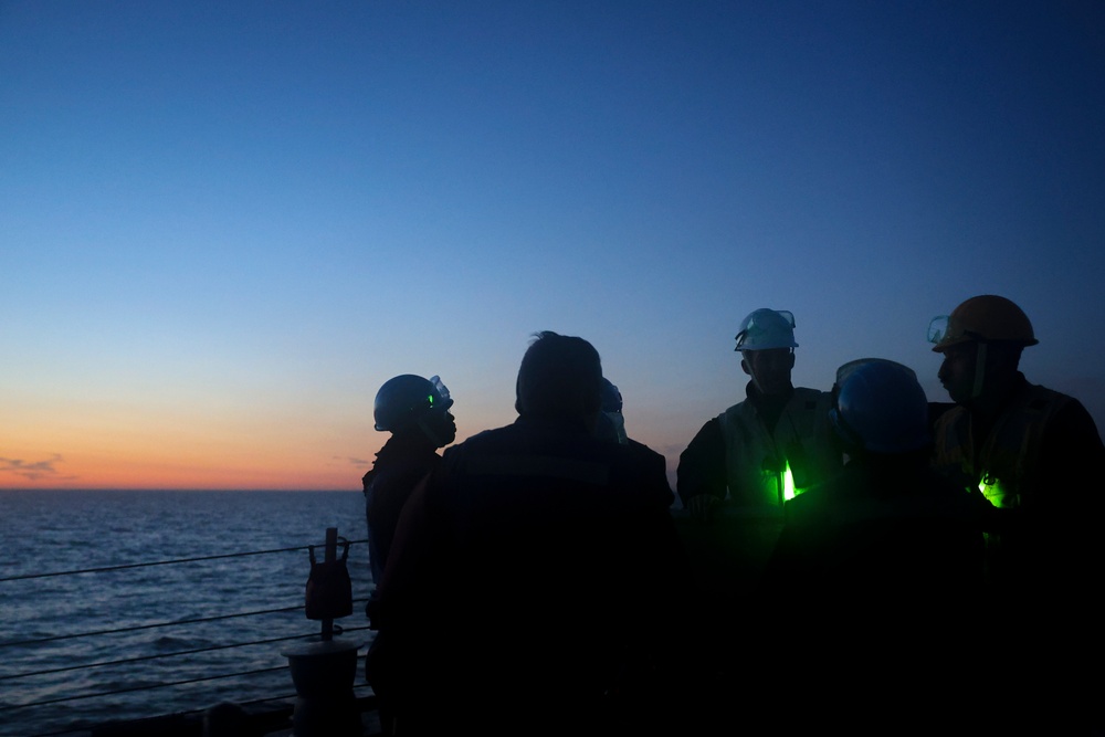 USS Bulkeley Sailors conduct a safety brief on the foc’sle prior to a night time sea-and-anchor transit
