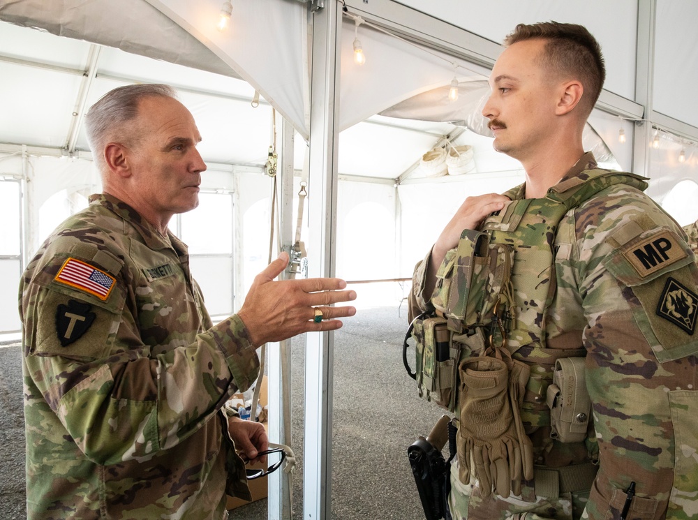 U.S. Army Maj. Gen. Ronald Burkett II, National Guard Bureau, speaks with a MS Guard Soldier