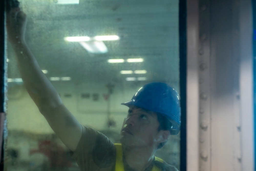 Tripoli Sailor Cleans Windows of the Hanger Deck Control Room