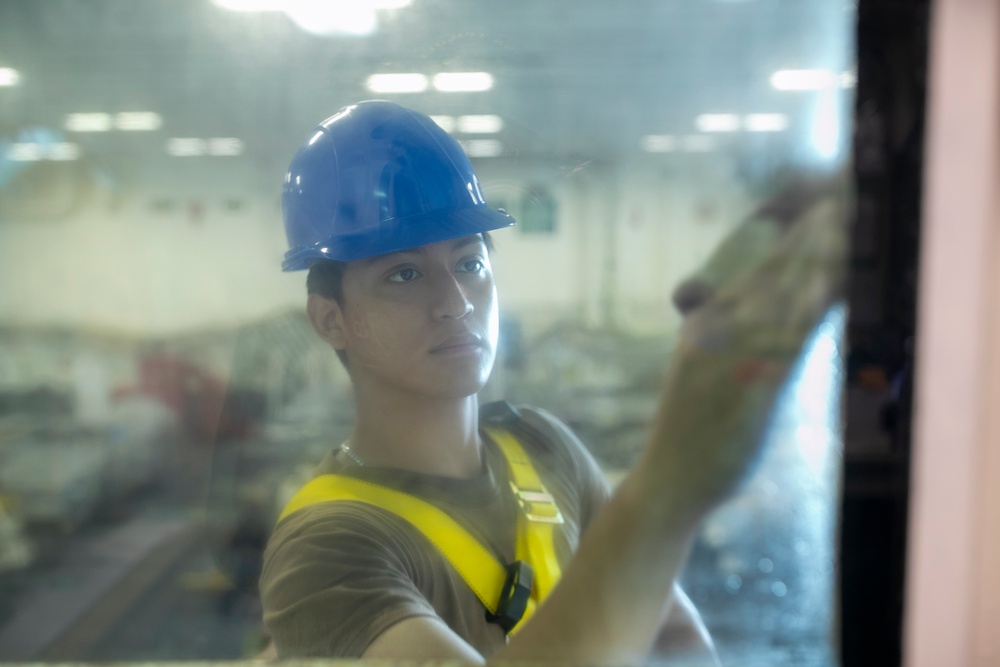 Tripoli Sailor Cleans Windows of the Hanger Deck Control Room
