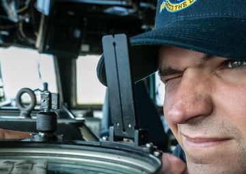 USS Mitscher (DDG 57) junior officer looks through navigational alidade