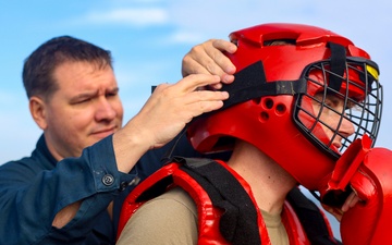 OS1 Casey Leverett and OS2 Kurt Goldsmith prepare for Non-Lethal Weapons training